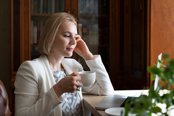 Portrait of a confident businesswoman with a cup of coffee.