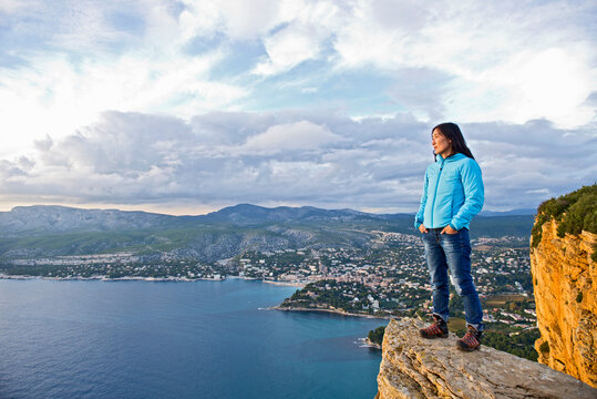 woman standing on top of a cliff at the French Cote d'Azur