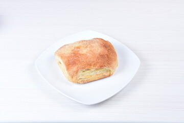 Puff pastry cake with arequipe and cheese, on a wooden background