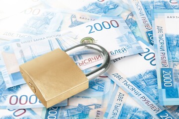 Padlock on money. Economic sanctions such as retaliation for war.