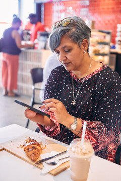 Woman using a cellphone at a coffee shop