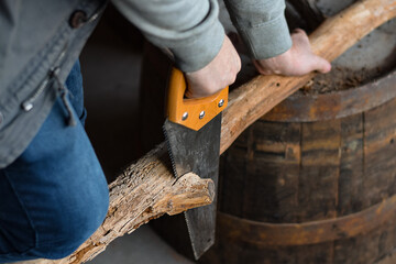 Man working on project with hand saw