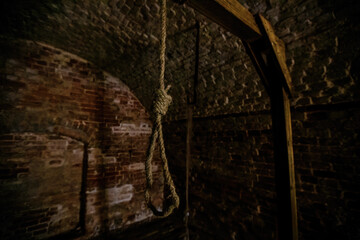 Hanging noose of rope in dark creepy abandoned cellar - obrazy, fototapety, plakaty