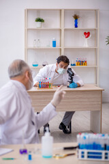 Two male chemist working at the lab