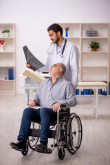 Old injured man visiting young male doctor radiologist