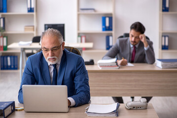 Two male colleagues working in the office