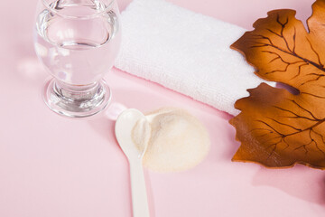 Collagen powder on pink background.