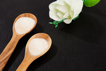 Collagen powder on black background.