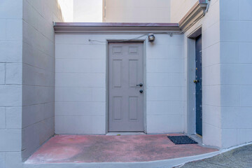 Two front doors with red concrete entrance in San Francisco, California