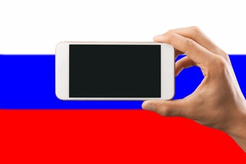 Hand holding phone with black screen for logo on  Russia flag background.