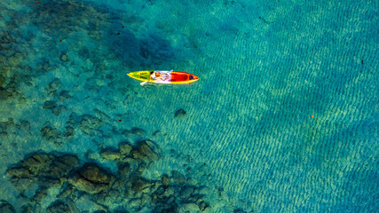 Aerial view of a kayak in the blue sea .man kayaking he does water sports activities.