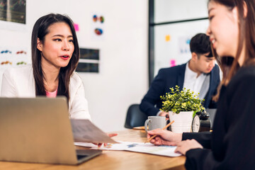 Group of asian business meeting and discussing strategy startup project analysis finance process.Success business people work plan and brainstorm marketing idea with laptop in office.Teamwork
