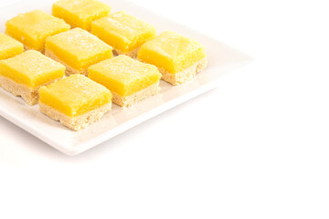Batch of Lemon Bars on a Square Dish Isolated on a White Background