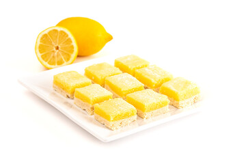 Batch of Lemon Bars on a Square Dish Isolated on a White Background