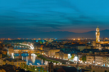 Fototapeta na wymiar Florence city during sunset. Panoramic view to the river Arno, with Ponte Vecchio and Palazzo Vecchio , Florence, Italy