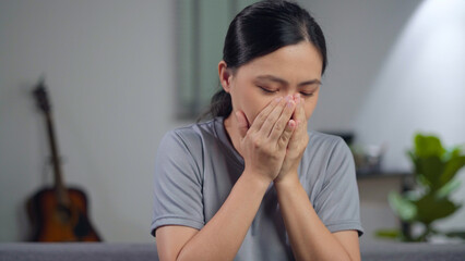 Asian woman was sick with fever getting cough.
