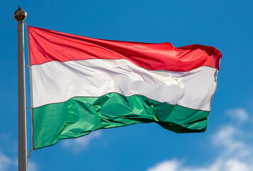 A close-up with the Hungarian flag waving in the wind