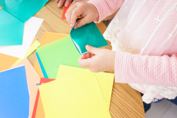 Child folding origami paper