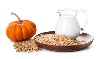 Jug with milk, oatmeal flakes and fresh pumpkin on white background