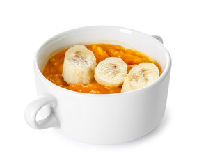 Pot of tasty oatmeal with pumpkin and banana on white background