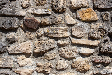 A close-up with an old stone wall
