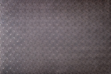 old sheet iron background, dark metal texture with diamond pattern.