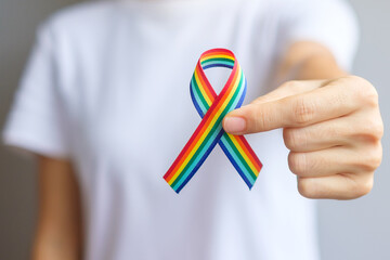 hand holding LGBTQ Rainbow ribbon for Support Lesbian, Gay, Bisexual, Transgender and Queer...