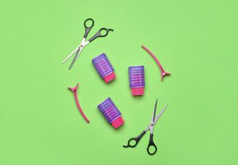Composition with hairdresser's tools and hair curlers on green background