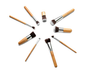 Frame made of new makeup brushes on white background