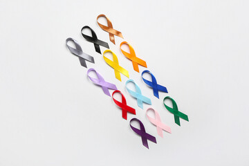 Set of different awareness ribbons on light background. World Cancer Day concept