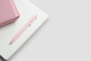 Notebooks and pen on light  background