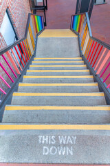 Outdoor concrete stairs with painted This Way Down note at the front in San Francisco, CA