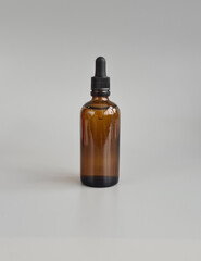 Glass bottle with oil for cosmetic product packaging mockup