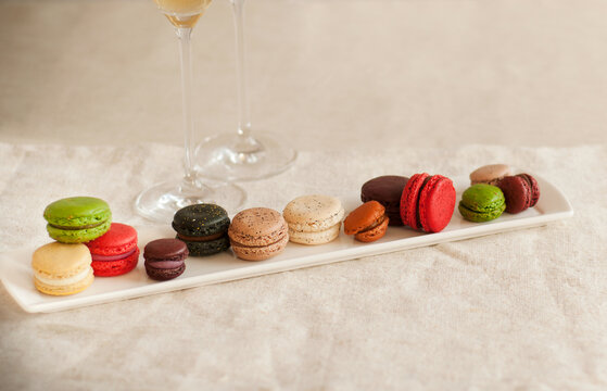 Long Platter of Various Colored Macaroons; Two Glasses of Champagne.