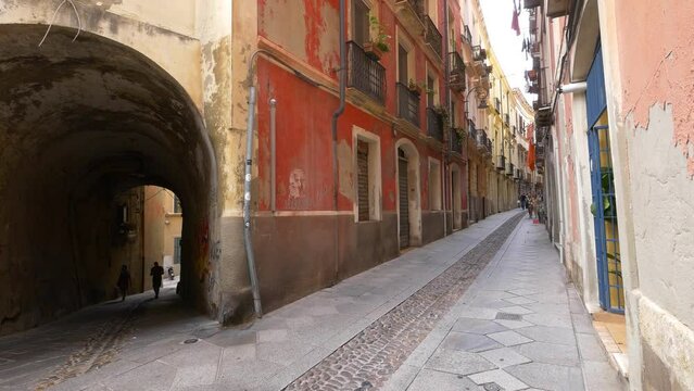 A typical street scene in Cagliari, Sardinia.  Narrow arch and street