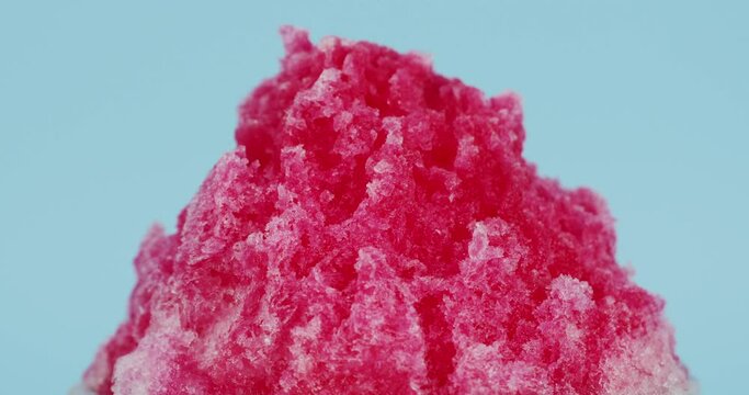 Close Up Zoom In Shaved Ice Dessert With Red Sauce On Blue Background.