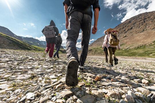 Group of walking hikers in mountains. Travel concept