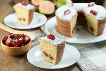 Brazilian corn cake made with a type of corn flour (Fuba) filled with guava paste. On a wooden party table. Typical sweets of the June festival. Cornmeal cake
