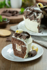 Close up piece of White chocolate and dark chocolate cake two loves on wooden table. Birthday and wedding cake