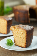 Close up piece of Brazilian corn cake made with a type of corn flour (Fuba). On a wooden party table. Typical sweets of the June festival. Cornmeal cake