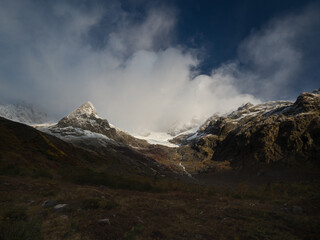 Misty foggy alpine mountains. Cold morning. Tour du Mont Blanc