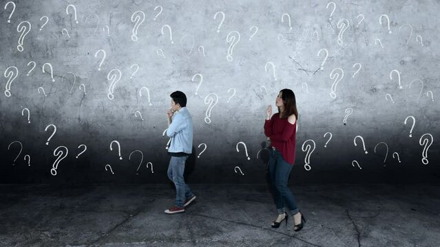 Confused couple walking with question mark symbol