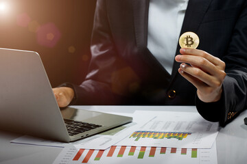 Business woman hold Bitcoin cryptocurrency actual coin in hand to present decentralized finance