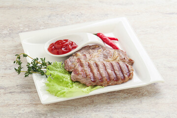 Grilled pork neck steak with ketchup