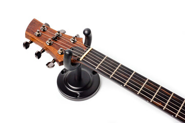 Wall mounted metal holder for acoustic or electric guitar. - obrazy, fototapety, plakaty
