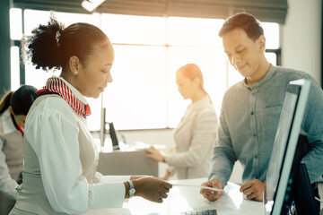 Obraz premium Flight attendant woman or Air hostess in uniform checking seats boarding pass and passport on the airplane before flight traveling.