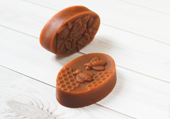 Rose Handmade Soap Take a photo with blooming roses On a white wooden floor., herbal soap., close-up photo.