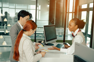Flight attendant woman or Air hostess in uniform checking seats boarding pass and passport on the airplane before flight traveling.