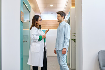 Female doctor discussing something with male patient