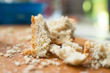 White bread crumbs close-up on a wooden cutting board. Leftovers after meals
